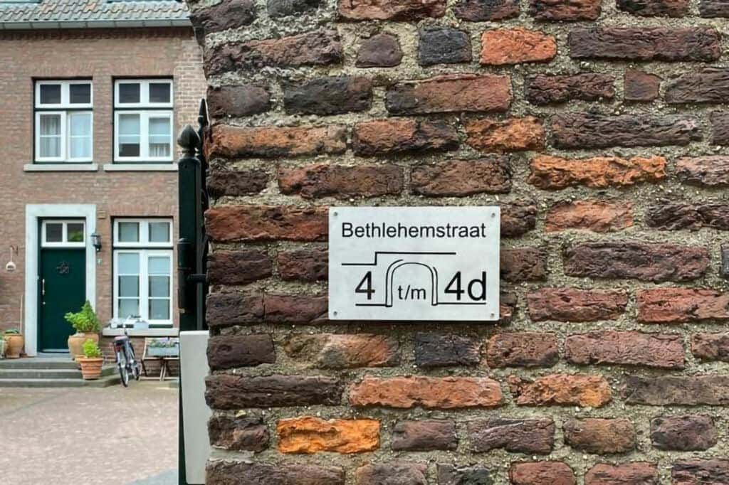 Gegraveerd RVS naambord op een buitenmuur